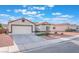 A lovely one-story home with a two-car garage, desert landscaping, and a concrete driveway at 629 Majestic Sky Dr, North Las Vegas, NV 89031