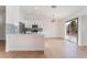 Bright kitchen with modern light fixture, hardwood floors, and sliding glass door to backyard at 629 Majestic Sky Dr, North Las Vegas, NV 89031
