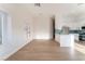 Open-concept living area with hardwood floors, modern lighting, and a view of the kitchen at 629 Majestic Sky Dr, North Las Vegas, NV 89031