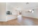 Open-concept living area with hardwood floors, modern lighting, and sliding glass door to backyard at 629 Majestic Sky Dr, North Las Vegas, NV 89031