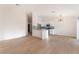 Spacious living area with hardwood floors, modern lighting, and a white kitchen with an island at 629 Majestic Sky Dr, North Las Vegas, NV 89031