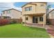 A backyard features an artificial lawn, a covered patio, and a wall for privacy at 6622 Palm Branch St, North Las Vegas, NV 89086
