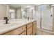 Bathroom with double sink vanity, large mirror, and glass-enclosed shower stall at 6622 Palm Branch St, North Las Vegas, NV 89086