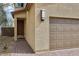 Close up of the front of the home with two car garage, and a brick paved driveway at 6622 Palm Branch St, North Las Vegas, NV 89086