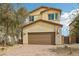 Inviting two-story home featuring a two-car garage and low-maintenance desert landscaping at 6622 Palm Branch St, North Las Vegas, NV 89086