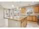Bright kitchen features an island with granite countertop and stylish pendant lighting, ample cabinets, and backyard access at 6622 Palm Branch St, North Las Vegas, NV 89086