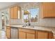 Modern kitchen featuring granite countertops, subway tile backsplash, and stainless steel appliances at 6622 Palm Branch St, North Las Vegas, NV 89086