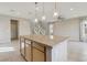 Island with granite counters, pendant lights, and plenty of counter space sits in the center of the open-concept living space at 6622 Palm Branch St, North Las Vegas, NV 89086