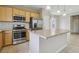 Open kitchen with stainless steel appliances, granite countertops, center island and ample cabinet space at 6622 Palm Branch St, North Las Vegas, NV 89086