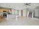 Open-concept living space boasts natural light, a staircase, and kitchen with island and stainless steel appliances at 6622 Palm Branch St, North Las Vegas, NV 89086