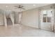 Open-concept design features tiled floors, a ceiling fan, staircase, and window for plenty of natural light at 6622 Palm Branch St, North Las Vegas, NV 89086