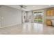 Bright living area with natural light, a ceiling fan, and sliding glass doors leading to backyard at 6622 Palm Branch St, North Las Vegas, NV 89086
