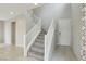 View of the home's carpeted staircase with white banister and railing, adjacent to the front door at 6622 Palm Branch St, North Las Vegas, NV 89086