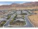Stunning aerial view of a modern suburban neighborhood with mountain views and well-maintained landscaping at 6690 Interstellar St, Las Vegas, NV 89135