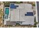 Aerial view of a home with a private pool, solar panels, lush landscaping, and outdoor seating at 6690 Interstellar St, Las Vegas, NV 89135