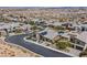Aerial view shows the neighborhood with a modern home featuring desert landscaping and solar panels on the roof at 6690 Interstellar St, Las Vegas, NV 89135