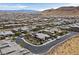 Expansive aerial view of a suburban neighborhood with a mix of modern homes and mountain scenery at 6690 Interstellar St, Las Vegas, NV 89135