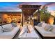 Inviting outdoor area features lounge seating, fire table, outdoor kitchen, and covered patio at 6690 Interstellar St, Las Vegas, NV 89135