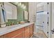 Stylish bathroom featuring green tile, double sinks, and modern fixtures at 6690 Interstellar St, Las Vegas, NV 89135