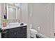 Stylish half-bathroom featuring patterned wallpaper and modern sink at 6690 Interstellar St, Las Vegas, NV 89135