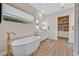 Elegant bathroom features a soaking tub, modern fixtures, and built-in shelves at 6690 Interstellar St, Las Vegas, NV 89135
