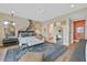 Modern bedroom with a king bed, a ceiling fan, and an ensuite bathroom at 6690 Interstellar St, Las Vegas, NV 89135