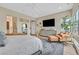 Bedroom boasts natural light, a cozy chair with ottoman, and a modern dresser at 6690 Interstellar St, Las Vegas, NV 89135