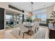 Well-lit dining room boasts modern lighting and glass doors with outdoor access at 6690 Interstellar St, Las Vegas, NV 89135