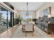 Elegant dining room with modern light fixture and sliding door to patio at 6690 Interstellar St, Las Vegas, NV 89135