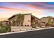 Modern home with a unique design, tiered landscaping, and a stylish three-car garage at 6690 Interstellar St, Las Vegas, NV 89135