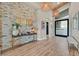 Grand foyer featuring stone accent wall, modern lighting, and stylish decor at 6690 Interstellar St, Las Vegas, NV 89135