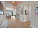 Inviting foyer features wood floors, high ceilings, and decorative lighting, flowing seamlessly into the open-concept living area at 6690 Interstellar St, Las Vegas, NV 89135