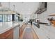 Well-appointed kitchen features a long island with bar seating, stainless steel appliances, and modern finishes at 6690 Interstellar St, Las Vegas, NV 89135