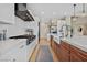 Modern kitchen featuring white cabinets, farmhouse sink, and stainless steel appliances at 6690 Interstellar St, Las Vegas, NV 89135