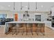 Modern kitchen features a large island with seating, stainless steel appliances, and ample counter space at 6690 Interstellar St, Las Vegas, NV 89135