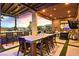 Elegant outdoor dining area with pergola, bar, and a view of the pool and desert landscape at 6690 Interstellar St, Las Vegas, NV 89135