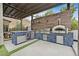Gourmet outdoor kitchen featuring a pizza oven, built-in grill, stainless steel appliances, and ample counter space at 6690 Interstellar St, Las Vegas, NV 89135