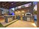 Gorgeous outdoor kitchen with built-in grill, pizza oven, and stylish bar area at 6690 Interstellar St, Las Vegas, NV 89135