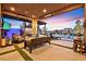 Inviting covered patio featuring comfortable seating, an outdoor kitchen, and views of the pool at 6690 Interstellar St, Las Vegas, NV 89135