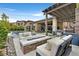 Backyard patio with an outdoor kitchen, outdoor seating, and views of the pool and mountains at 6690 Interstellar St, Las Vegas, NV 89135