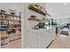 Pantry with white marble countertops, floating wooden shelves, and organized shelving at 6690 Interstellar St, Las Vegas, NV 89135