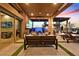 Covered patio features an outdoor kitchen, lounge seating, and a TV, offering the perfect space for relaxation and entertainment at 6690 Interstellar St, Las Vegas, NV 89135