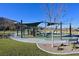 A community playground featuring modern play structures and safety surfaces for children to enjoy in a secure environment at 6690 Interstellar St, Las Vegas, NV 89135