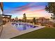 This backyard oasis boasts a sparkling pool with a built-in lounge area and an outdoor kitchen perfect for entertaining at home at 6690 Interstellar St, Las Vegas, NV 89135