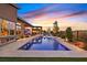 Beautiful pool, complete with a built-in lounge area and a beautiful outdoor kitchen at this luxury home with a backyard pool at 6690 Interstellar St, Las Vegas, NV 89135