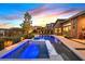 Stunning pool and spa with built-in seating create a relaxing outdoor oasis at twilight at 6690 Interstellar St, Las Vegas, NV 89135