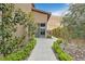 Well-manicured side yard with stone pavers, lush landscaping, and views of the surrounding hills at 6690 Interstellar St, Las Vegas, NV 89135