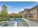 Stylish swimming pool area with a spa, in-pool loungers, and views of the landscaped backyard at 6690 Interstellar St, Las Vegas, NV 89135