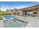 Backyard swimming pool with integrated spa, in-pool seating, and a sunbathing area with lounge chairs at 6690 Interstellar St, Las Vegas, NV 89135