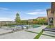 Beautiful swimming pool and spa featuring tile trim, built-in loungers, and a mountain view at 6690 Interstellar St, Las Vegas, NV 89135